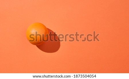 top view of isolated orange fruit on an orange background. Minimalist concept. Copy space