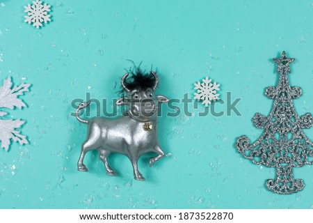 Toy bull on a blue background. The symbol of the new 2021. Good New Year mood.