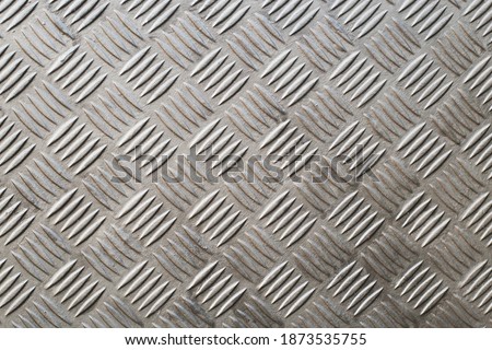 A Industrial metal checker plate. Metal checker plate texture background. Metal checkerplate for anti skid. Embossed metal sheet.
