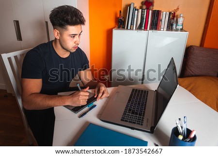 Young man working at home with a laptop
