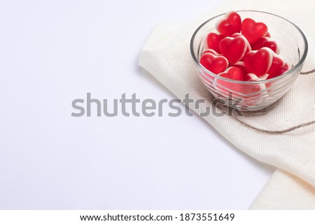 Gelatin hearts in a glass transparent saucer on a white background. Valentine's day concept.