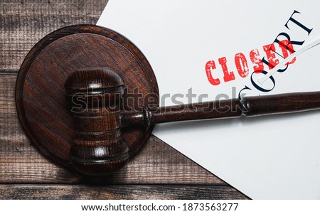 Judge's gavel with a file. Briefcase with the word Court and Closed. The concept of recognizing court cases, conducting court proceedings.