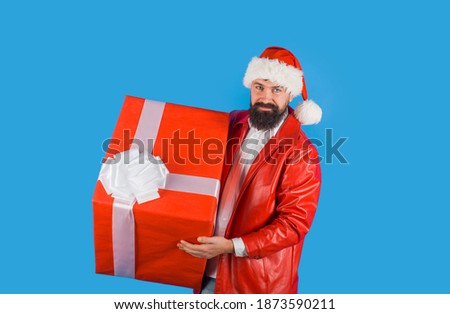 Santa with big present. New year gift. Christmas decorations. Santa Claus gifting present. New year gift. Present box.