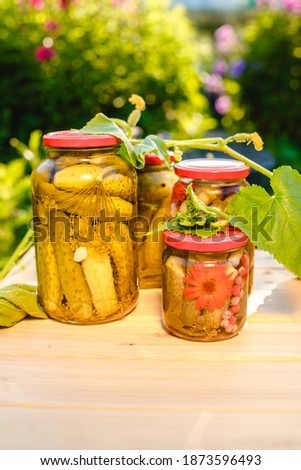 Pickled cucumbers in a jar. Autumn harvesting. Pickled and salted vegetables. Preservation for the winter. Summer country hobby.