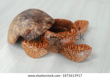 Turtle shaped ashtray made of clay - isolated on white. Ashtray turtle made of coconut palm wood