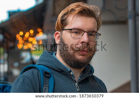 common male person mustache and bearded man face portrait street urban style picture with garland lights background view 