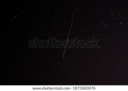 Geminids meteor on sky night background, star tail of Geminids in space of nature 