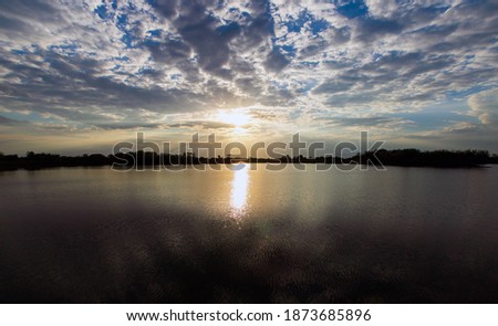 Natural Sunset Sunrise. Bright Dramatic Sky And Dark Ground. Countryside 
Landscape Under Scenic Colorful Sky.
