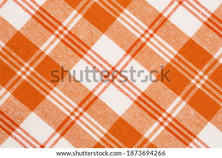 Orange and white kitchen towels texture as a background, vertical picture.