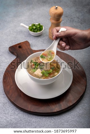 girl eating freshly prepared vegetable soup 