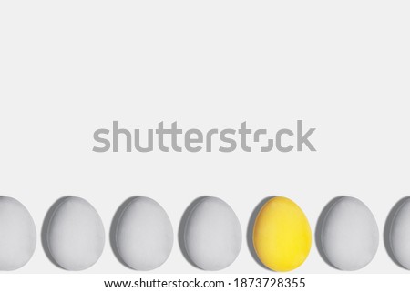 Gray and yellow eggs in the color of the year 2021 on a light background copy space Easter