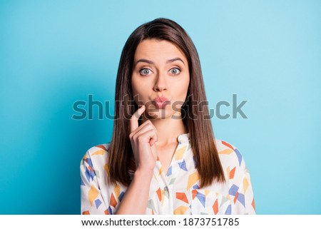 Photo of pretty young girl finger cheek look camera space funny face lips wear geometry print shirt isolated blue color background