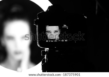 Portrait of a beautiful girl through lens Royalty-Free Stock Photo #187375901