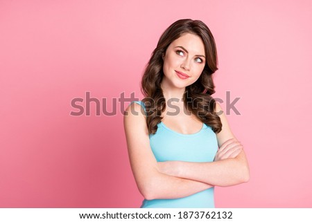 Photo of pretty sweet lady standing crossed arms look empty space wear blue top isolated on pastel pink color background