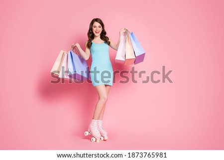 Full size photo of young smiling happy attractive girl woman wear rollers hold bags shopping isolated on pink color background