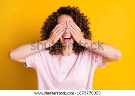 Photo of curly brown hair positive happy smile girl hands cover close eyes isolated over yellow color background