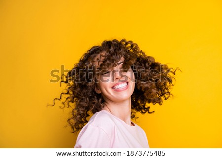 Photo portrait of girl waving curly hair isolated on vivid yellow colored background Royalty-Free Stock Photo #1873775485