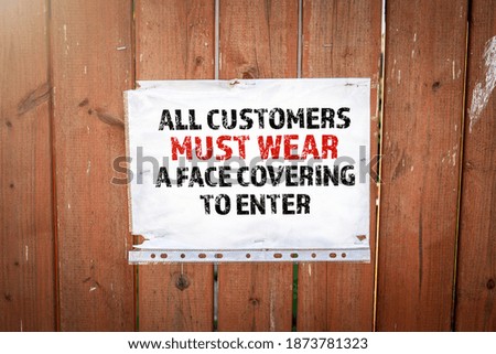All customers must wear a face covering to enter. Information at the wooden fence