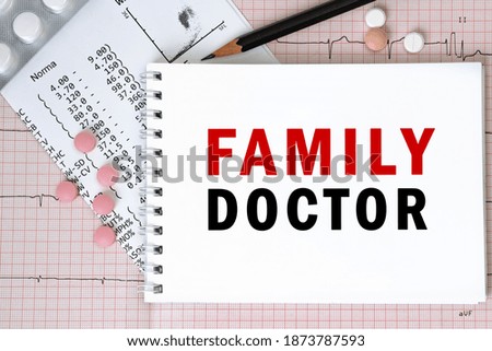 Notebook page with words - FAMILY DOCTOR nearby with a pills and pencil, medical concept, top view