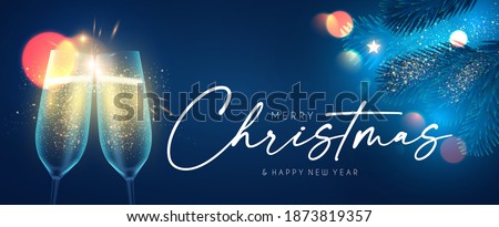Merry Christmas and Happy New 2021 Year background with champagne glasses, fir tree branches, lights and bokeh effect.
