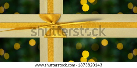 Festive decorative Christmas birthday holiday background banner panorama - Golden yellow gift boxes  presents with ribbon isolated on dark green background with yellow golden bokeh lights