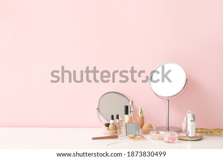 Set of decorative cosmetics and mirrors on dressing table Royalty-Free Stock Photo #1873830499