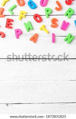 Colourful alphabet on white wooden background. Language school concept 