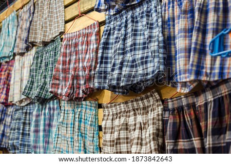 Boxer shorts of various colors and plaid patterns for sale at a tiangge, boutique or flea market. Cheap wholesale Men's underwear. Royalty-Free Stock Photo #1873842643