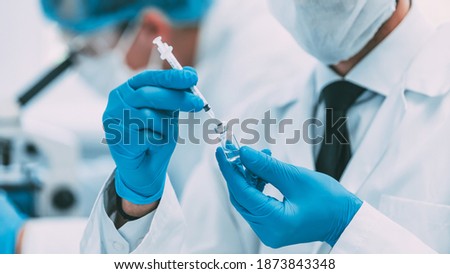 close up. group of scientists conducting trials of the new vaccine . Royalty-Free Stock Photo #1873843348
