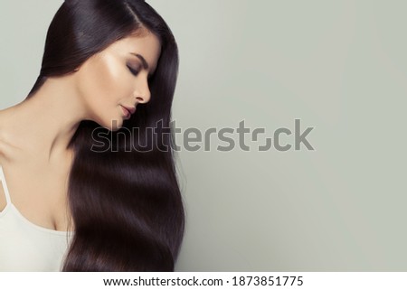 Pretty young woman with long healthy hair on white background, beautiful female face profile
