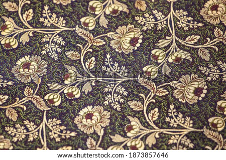 Jacquard fabric, floral motif. Close-up of elegant and splendid silk fabric with a floral ornament.  Royalty-Free Stock Photo #1873857646