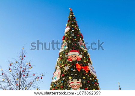 Artificial Christmas tree against the blue sky on a Sunny day in the center of Moscow. Horizontal orientation
