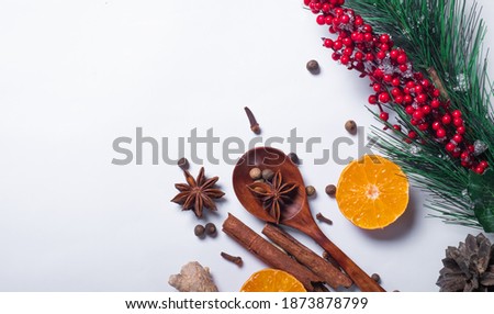 Set of aromatic spices and orange on a white background for mulled wine. Aromatic background and warming background.