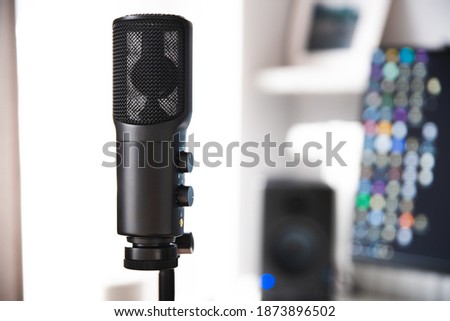 detailed microphone shot with desk station in background podcast