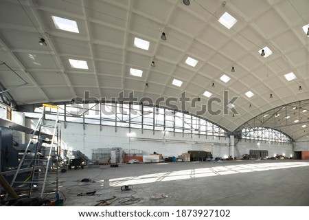 Huge industrial warehouse. Green truck. Unique architecture. Hemispherical reinforced concrete load bearing roof with windows.
