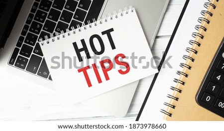 Hot tips text in a notebook, business concept