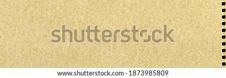 Brown and beige colored cardboard detail, hole cardboard paper texture as background