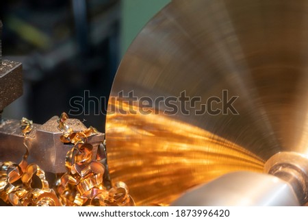 The operation of lathe machine cutting the brass material  parts with the cutting tools. The metalworking process by turning machine.