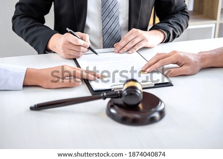 Agreement prepared by lawyer signing decree of divorce (dissolution or cancellation) of marriage, husband and wife during divorce process with male lawyer or counselor and signing of divorce contract. Royalty-Free Stock Photo #1874040874