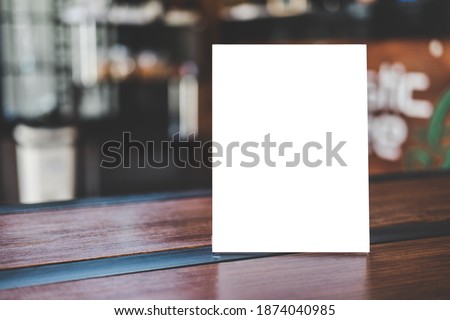 Mock up acrylic frame posters pattern template forms background, blank menu frame on table in coffee shop stand for your text of display your product.