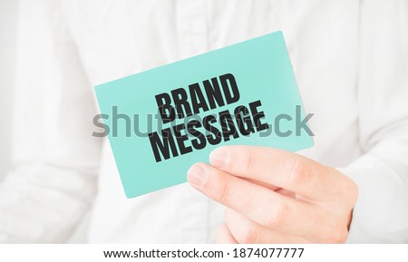 Businessman in white shirt holding a green card with text Market Intelligence on effort