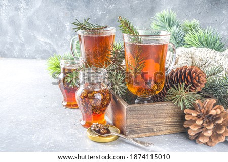 Pine Cone tea, aromatic organic winter hot tea drink with pine branch and pine cone jam, sweet and healthy winter drink concept Royalty-Free Stock Photo #1874115010