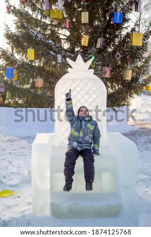 happy boy sitting on the icy throne