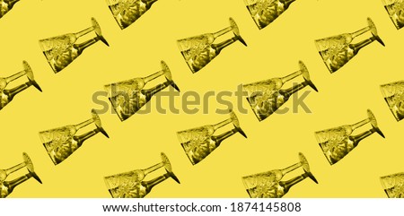 Champagne glass pattern on the illuminating yellow background. Trendy color of the year 2021
