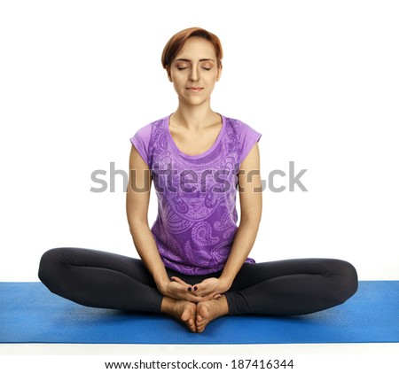 Young pretty woman sitting in one of the yoga postures.