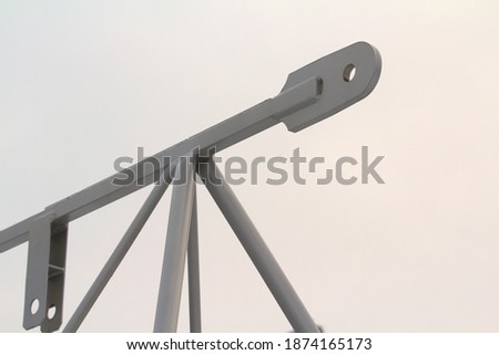 Boom spare part for construction crane, gray metal structures on gray background Stock photo with empty space for text and design. 