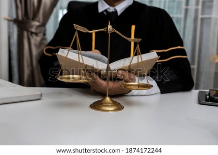 Justice and law concept. Lawyer man reading a book at table office. 