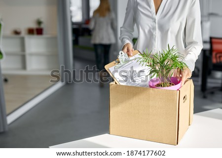 caucasian female employee intern holding cardboard box with belongings start or finish job in company, blonde busnesswoman newcomer worker get hired fired on first last day at work concept Royalty-Free Stock Photo #1874177602