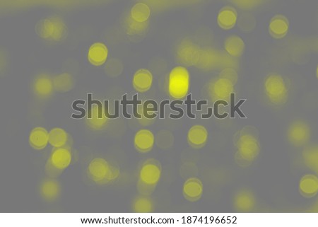 Abstract bokeh background in trendy 2021 new colors. Illuminating Yellow and Ultimate Gray. Color of the Year 2021. Christmas bokeh lights defocused blurred background