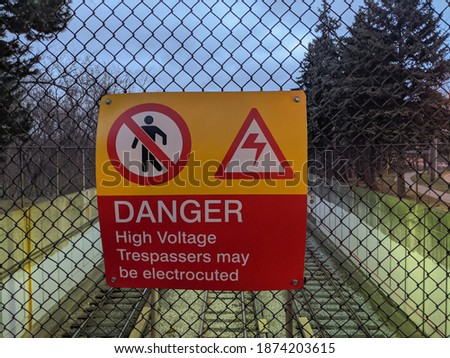 Sign danger high voltage trespassers may be electrocuted near the subway line.
